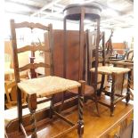 An Edwardian mahogany plant stand, and two ladderback chairs.
