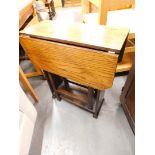 A 1920s oak drop leaf table with rectangular top and canted corners.