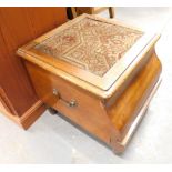 A Victorian box commode with embroidered top.