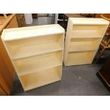 Two cream painted bookcases.