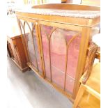 A mid 20thC walnut bow front display cabinet, with astragal glazed doors.