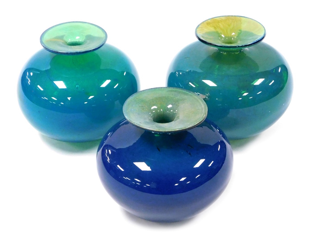 Three Mdina blue and green glass vases, two 12.5cm high, one 11.5cm high.