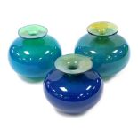 Three Mdina blue and green glass vases, two 12.5cm high, one 11.5cm high.