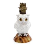 A late 19thC Continental porcelain table lamp, modelled as an owl, in standing pose on a naturalisti