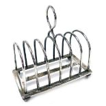 An Edward VII silver six division toast rack, of plain form with a ring handle, raised on four ball