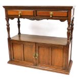 A Victorian oak buffet, with two frieze drawers raised on turned and fluted columns, over two cupboa