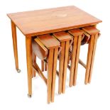 A 1970s teak nest of four tables, the largest rectangular table with turned legs, sold with four sma