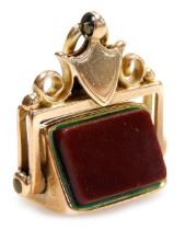 A 9ct gold bloodstone and carnelian swivel fob, with a shield shaped mount, 6.2g.