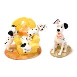 A Royal Doulton Disney's 101 Dalmatians figure group, modelled as Pups in the Armchair, DM11, and an