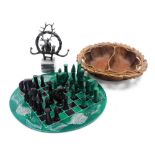 An African hardstone chess set, with black and green pieces, on a circular chess board, decorated to