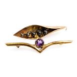 An amethyst set V shaped bar brooch, stamped 9ct, together with a further brooch formed as a leaf of
