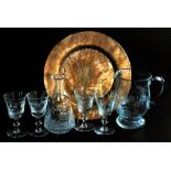 A copper salver, together with a cut glass water jug, together with four wine glasses, variously eng