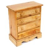 A pine chest of drawers, the rectangular top above four drawers, each with turned wood handles, on b