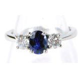 A sapphire and diamond three stone trilogy ring, with oval sapphire approx 0.89ct, in a four claw se