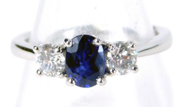 A sapphire and diamond three stone trilogy ring, with oval sapphire approx 0.89ct, in a four claw se
