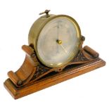 A Victorian brass cased holosteric barometer, in a carved oak stand, 25.5cm wide.