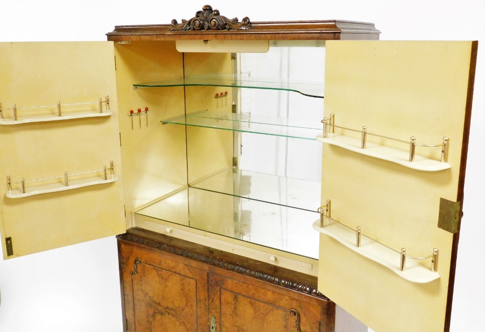 A reproduction walnut drinks cabinet, with carved crest to the top and fitted cabinet below enclosed - Image 2 of 2