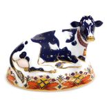 A Royal Crown Derby porcelain Friesian Cow 'Buttercup' porcelain paperweight, red printed marks and