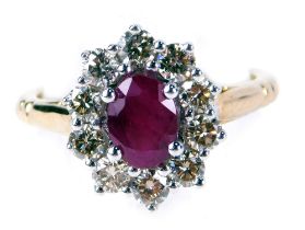 A ruby and diamond cluster ring, with an oval cut ruby, totalling approx 0.80cts, in four claw setti