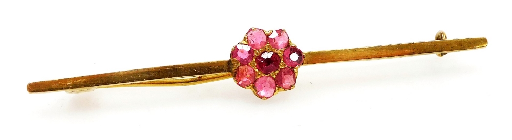 A ruby seven stone flower head bar brooch, in yellow metal, unmarked, possibly Burmese rubies, 4.5g.