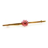 A ruby seven stone flower head bar brooch, in yellow metal, unmarked, possibly Burmese rubies, 4.5g.