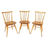 A set of three Ercol ash and elm stick back chairs, each with a solid seat on turned legs with stret