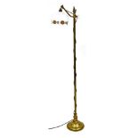 An early 20thC brass standard lamp, the adjustable arm with shade, printed with design of poppies, t
