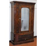 A Victorian walnut wardrobe, the outswept pediment over a single door with domed glass plate, enclos
