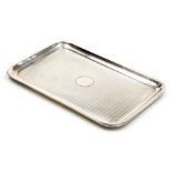 A George V silver rectangular tray, with engine turned decoration, circular vacant reserve, Birmingh