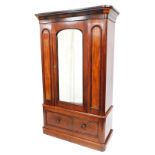 A late Victorian figured mahogany wardrobe, the top with a moulded cornice above a single mirrored g