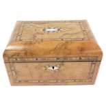 A Victorian walnut and inlaid box, with mother of pearl escutcheons, the hinged lid opening to revea