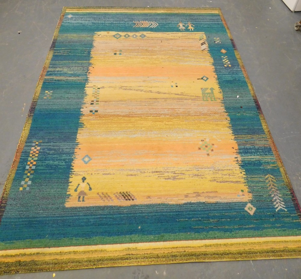 A Caucasian yellow and blue ground rug, decorated with stylised figures, animals, etc., 276cm x 201c