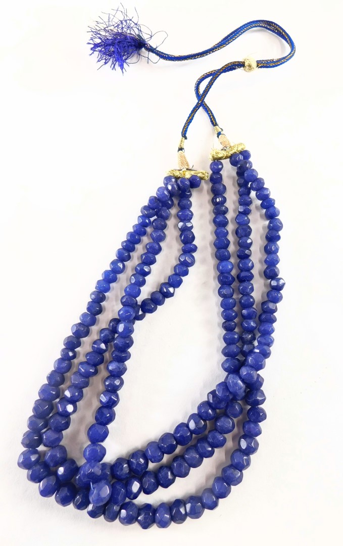 A reconstituted sapphire beaded necklace, of graduated form with three strands on a adjustable slip - Image 2 of 2