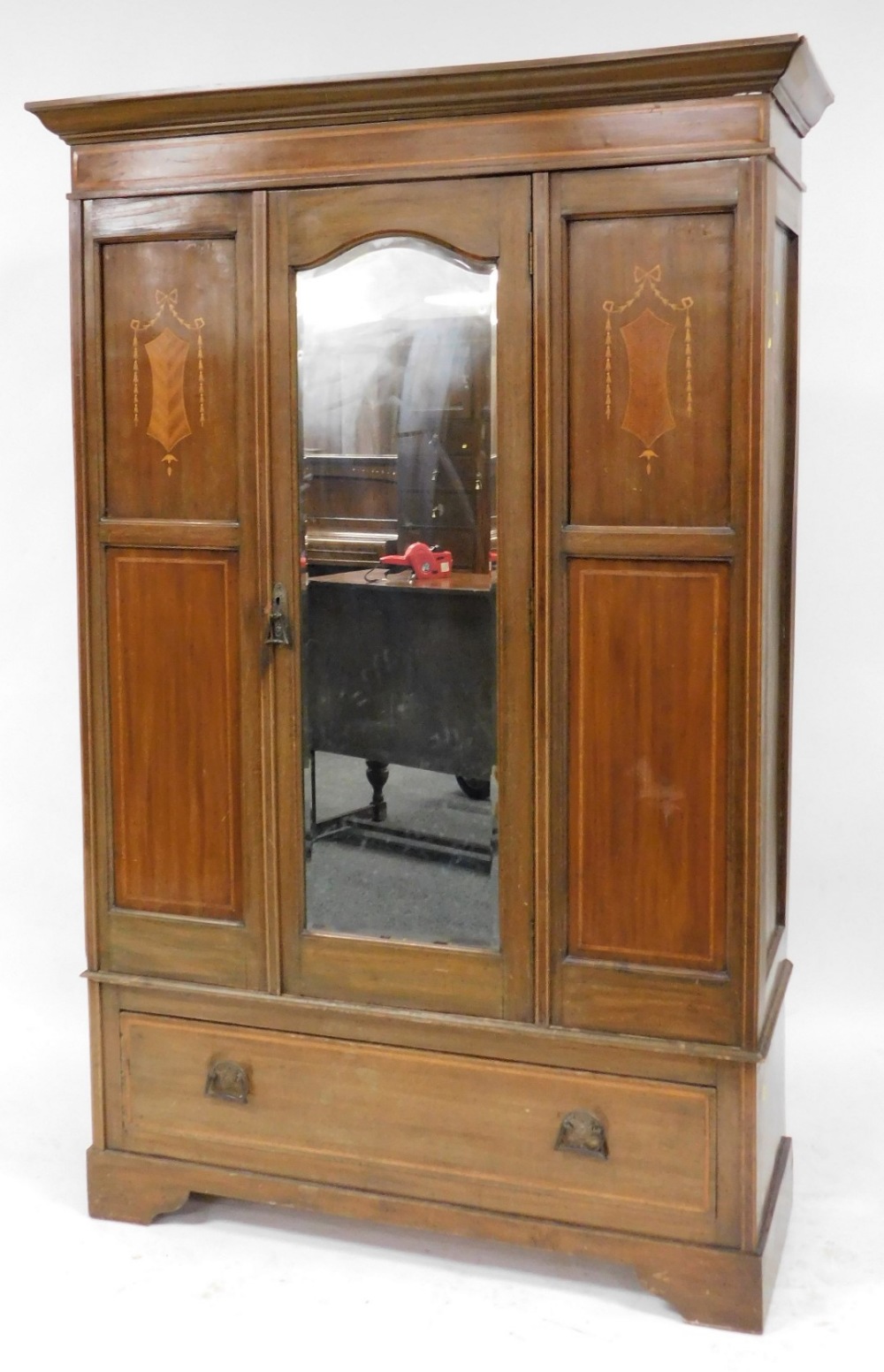 An Edwardian mahogany and inlaid double wardrobe, the outswept pediment over a single door, inset be