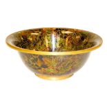 A Chinese cloisonne enamel bowl, decorated with flowers against a red ground, 18cm wide.