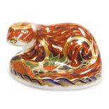 A Royal Crown Derby porcelain Otter paperweight, red printed marks and gold stopper, 7cm high.