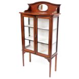 A 1920s inlaid mahogany Sheraton revival display cabinet, with arched gallery back, fitted mirror, a