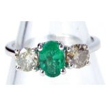 An 18ct white gold emerald and diamond trilogy ring, with round brilliant cut emerald, totalling 0.6