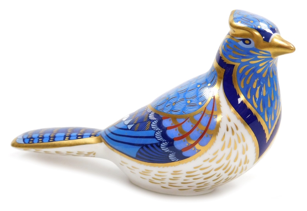 A Royal Crown Derby porcelain Blue Jay paperweight, red printed marks and gold stopper, 16cm wide.