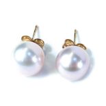 A pair of 9ct gold cultured pearl studs, each on a single pin back with butterfly back in a pinkish