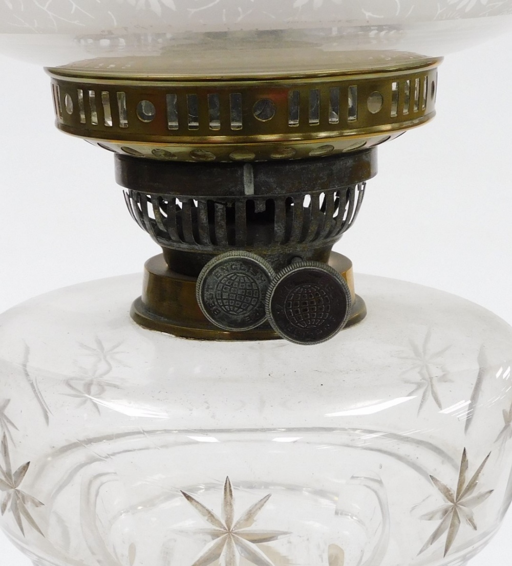 A late 19thC cut glass and brass oil lamp, with a clear and opaque floral etched shade, clear cut gl - Image 2 of 2