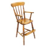 A 19thC ash and elm child's high chair, with turned supports, shaped arms, and a solid seat, on turn