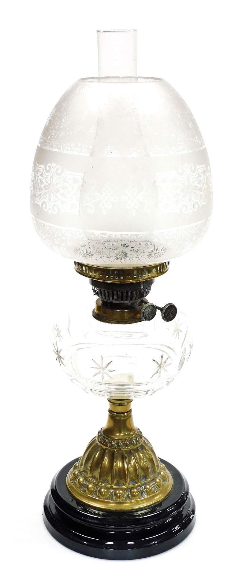 A late 19thC cut glass and brass oil lamp, with a clear and opaque floral etched shade, clear cut gl