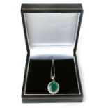 An 18ct gold emerald and diamond cluster pendant, with oval emerald, totalling approx 3.55ct, in a f