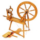 An oak spinning wheel, with turned spokes and legs, and various accessories, 87cm wide.