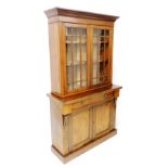 A walnut bookcase, the associated top with a moulded cornice and two astragal glazed doors, the base