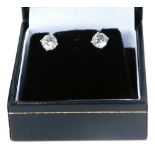 A set of 18ct white gold diamond stud earrings, each with round brilliant cut diamond, in a four cla