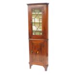 An Edwardian mahogany and inlaid standing corner cabinet, with a moulded cornice and canted sides, t