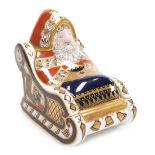 A Royal Crown Derby porcelain Santa in Sleigh paperweight, red printed marks and gold stopper, 10cm