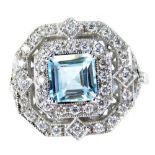 An Art Deco style aquamarine and diamond double halo ring, with a central asscher cut aquamarine, ap